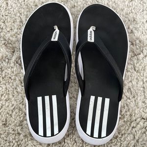 Black and white Adidas flip flops